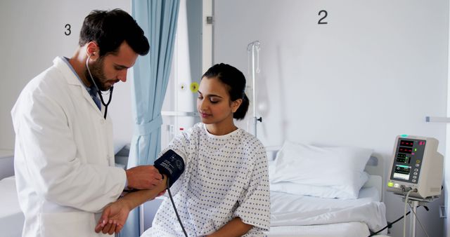 Male Doctor Taking Female Patient's Blood Pressure in Hospital Room - Download Free Stock Images Pikwizard.com