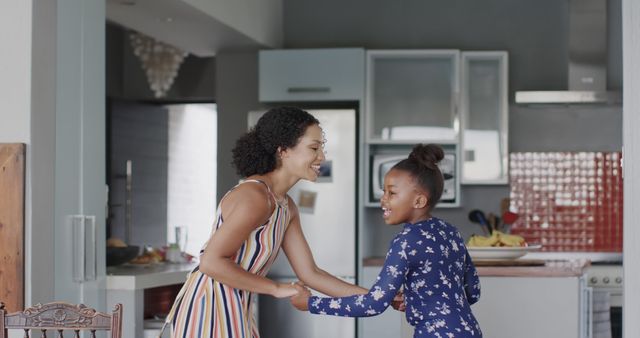 Happy Mother and Daughter Dancing Together in Kitchen - Download Free Stock Images Pikwizard.com