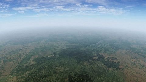 High-altitude view of sprawling agricultural plains, patchwork fields, winding river