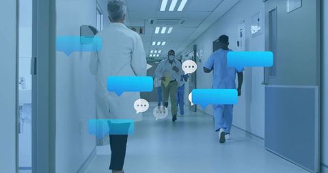 Healthcare team communicating via digital messaging in hospital corridor