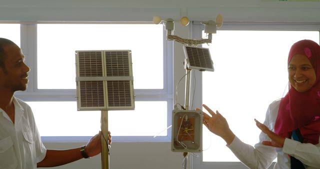 Happy Engineers Displaying Solar Powered Equipment - Download Free Stock Images Pikwizard.com