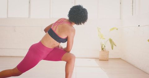 Biracial Yoga Instructor Practicing Pose in Bright Studio