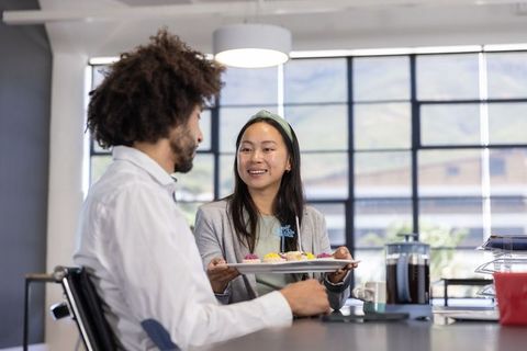Colleagues Sharing Cupcakes and Coffee in Office Break Room