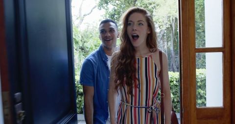 Excited couple entering new home, embracing fresh beginnings with joy