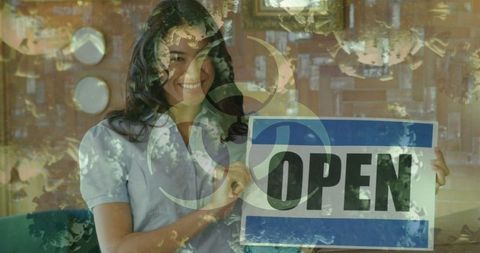 Smiling Woman Holding Open Sign in Retail Environment