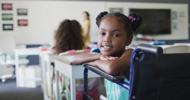 Young girl in a wheelchair smiling in a classroom showing inclusive education and diversity. Can be used for promoting inclusive learning, educational materials, school websites, and awareness campaigns about disabilities and diversity.
