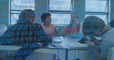 Elementary students collaborating on tablet with binary overlay for coding and stem learning