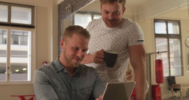 Two Men Discussing Ideas While Looking at Tablet in Office - Download Free Stock Images Pikwizard.com