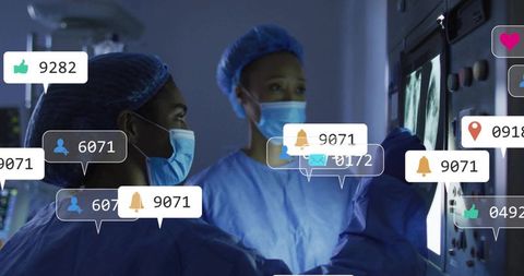 Surgical team reviewing CT and X-ray scans on monitors, collaborating in dim radiology hub