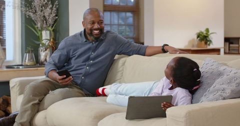 Father and Daughter Bonding at Home with Technology Devices