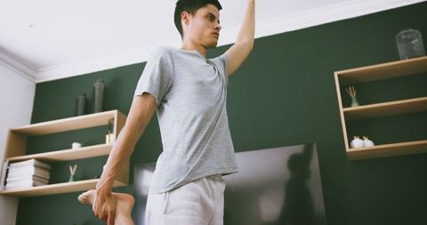 Man Practicing Yoga Hold in Stylish Living Room