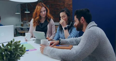 Coworkers Engaged in Collaborative Team Meeting in Modern Office
