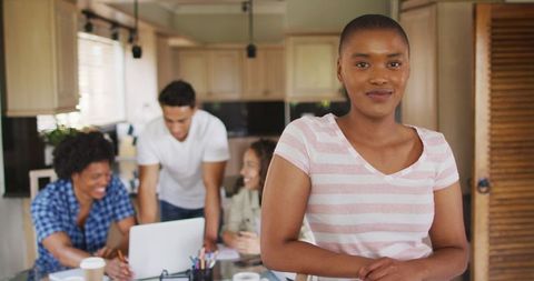 Confident African American Woman with Friends in Creative Workspace