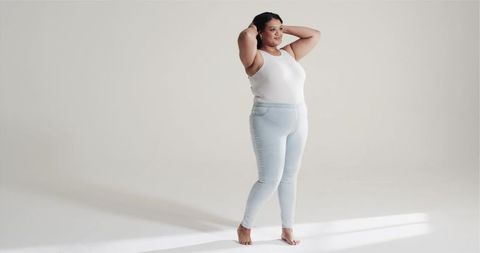 Confident Woman in Casual Athletic Wear Adjusting Hair