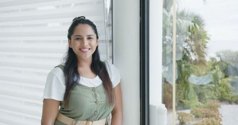 Smiling Asian Indian Woman Indoors Displaying Tranquility and Style