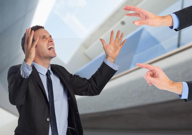 Frustrated businessman shouting and gesticulating during office conflict. Ideal for articles discussing workplace stress, professional disagreements, conflict resolution, or team dynamics.