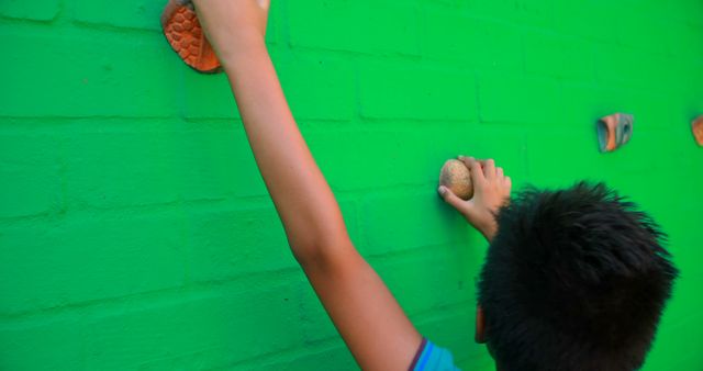 Child Climbing on Green Wall with Handholds Outdoors - Download Free Stock Images Pikwizard.com