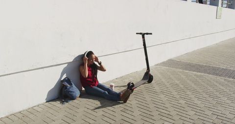Woman Relaxing on Pavement with Electric Scooter Enjoying Technology - Download Free Stock Images Pikwizard.com