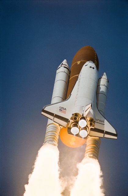 STS054-S-062 (13 Jan 1993) --- A low-angle view of the Space Shuttle Endeavour as it soars off the launch pad and heads toward Earth orbit with a crew of five and the Tracking and Data Relay Satellite (TDRS-F) aboard.  Launch occurred at 8:59:30 a.m. (EST), January 13, 1993.  Onboard were John H. Casper, mission commander, Donald R. McMonagle, pilot, Gregory J. Harbaugh, Mario Runco Jr., and Susan J. Helms, mission specialists.