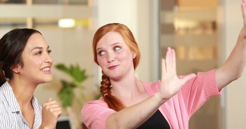 Women Celebrating Successful Collaboration in Office