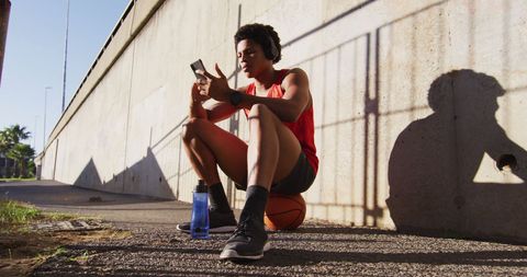 Athletic Man Relaxing with Smartphone and Basketball - Download Free Stock Images Pikwizard.com