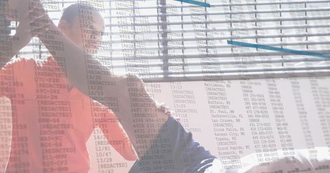 Senior man receiving shoulder therapy from caregiver in bright room with blinds overlay