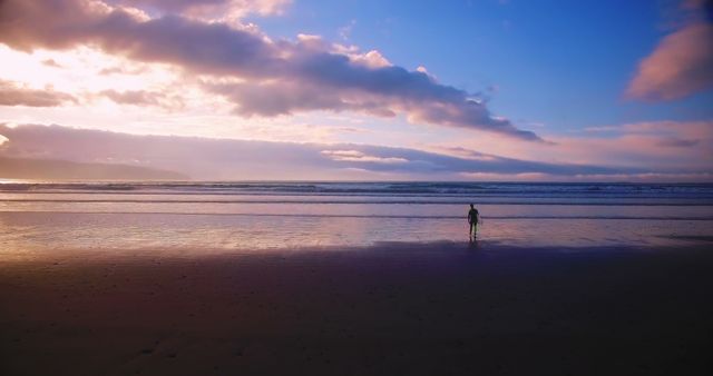 Solitary Child Walking Along the Beach at Sunset with Vibrant Skies - Download Free Stock Images Pikwizard.com