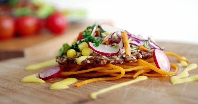 A colorful raw vegetable lasagna with layers of shredded carrots, zucchini, radishes, and sprouts, garnished with herbs. It's a vibrant and healthy dish showcasing a creative take on traditional lasagna, ideal for those seeking a nutritious meal.