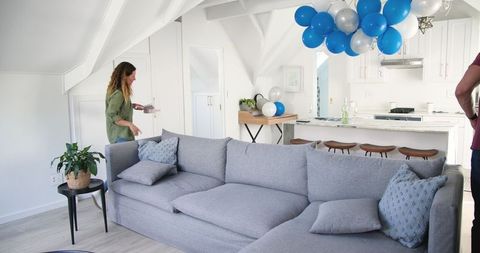 Cleaning Up After Home Birthday Celebration in Modern Living Space