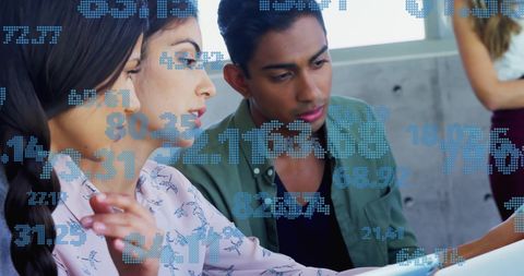 Diverse Colleagues Engaging with Digital Data in Office Environment