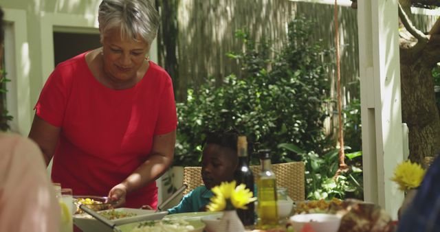 Grandmother Serving a Family Meal at Outdoor Garden Table - Download Free Stock Images Pikwizard.com