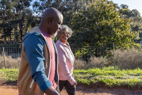Senior couple enjoying outdoor walk on sunny day