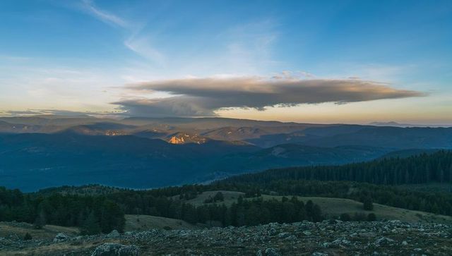 Lenticular Cloud Hovering Over Alpine Ridge at Sunset on Rocky Plateau Panorama