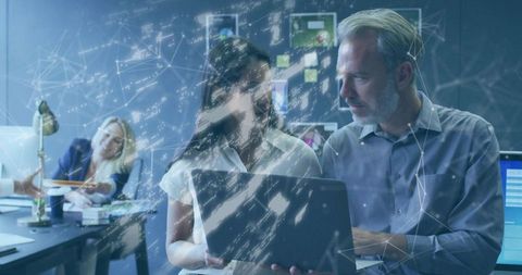 Coworkers Analyzing Laptop with Network Overlay Graphic