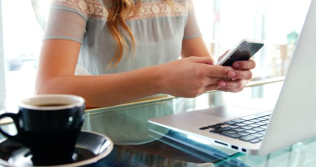 Woman Using Smartphone While Working at Cafe with Coffee Cup - Download Free Stock Images Pikwizard.com