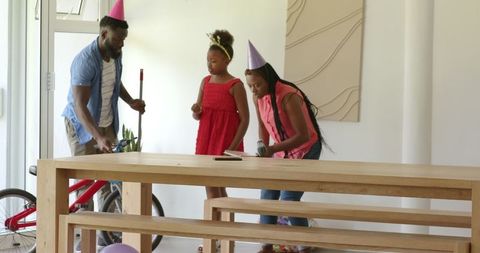 Family celebrating at home preparing decorations for party