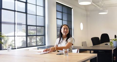 Businesswoman in Modern Office Engaging in Discussion