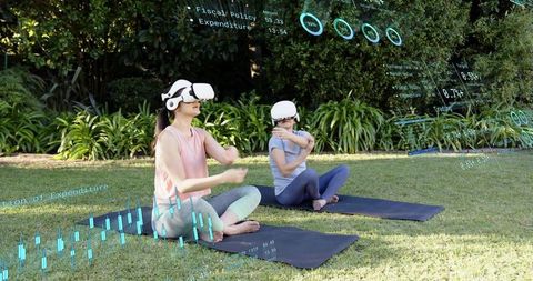 Two women practicing outdoor vr yoga with holographic ar fitness data overlays on mats