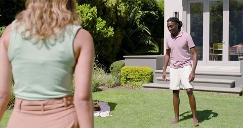 Friends Enjoying Outdoor Game Together in Sunny Garden