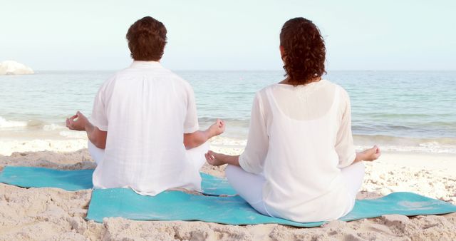 Couple Meditating on Beach in Peaceful Setting - Download Free Stock Images Pikwizard.com