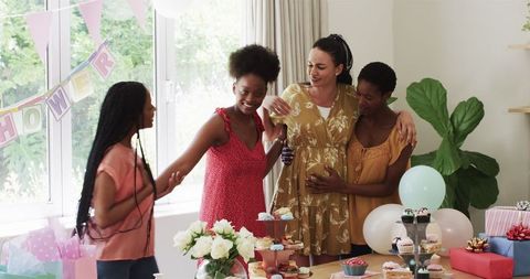 Mother-To-Be Surrounded by Friends Celebrating Upcoming Arrival