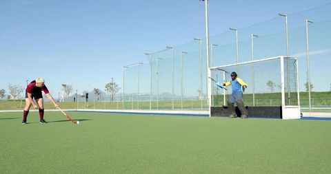 Field Hockey Player Faces off Against Goalkeeper Action Scene
