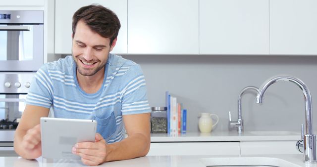Young Man Using Tablet in Modern Kitchen - Download Free Stock Images Pikwizard.com