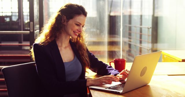 Happy Businesswoman Working on Laptop in Modern Office - Download Free Stock Images Pikwizard.com