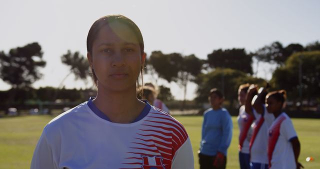 Determined Female Soccer Player Standing on Field with Teammates - Download Free Stock Images Pikwizard.com