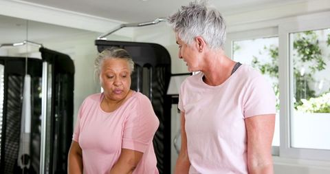 Senior Women Exercising with Dumbbells in Home Gym