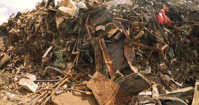 Large piles of metal scrap at a recycling yard illustrating industrial waste management and recycling processes. Suitable for use in articles about environmental conservation, recycling, sustainability initiatives, and industrial waste management.