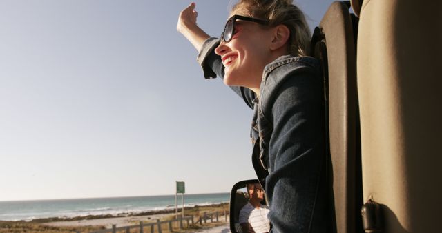 Joyful Woman with Sunglasses Enjoying Coastal Road Trip - Download Free Stock Images Pikwizard.com