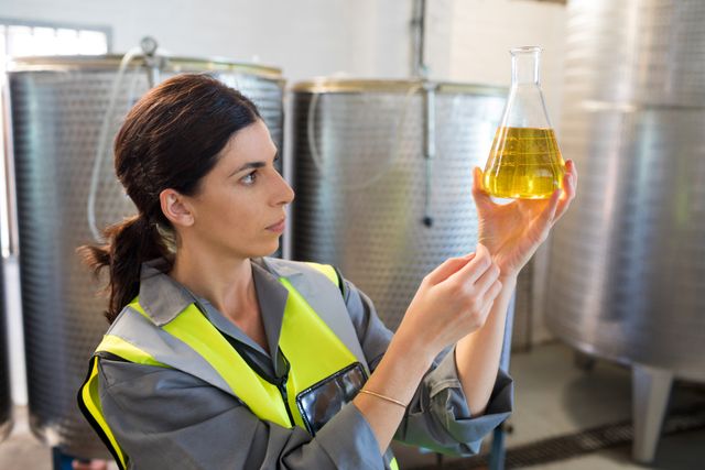 Female technician examining olive oil - Download Free Stock Photos Pikwizard.com