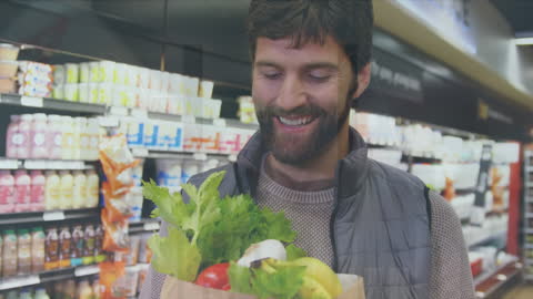 Man Shopping for Fresh Produce Smiling in Grocery Store